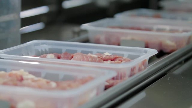 Packaging meat on the production line at the factory