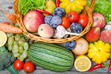 Fruits and vegetables in the basket top view.