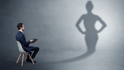 Fototapeta premium Rich businessman staying and offering stuffs to a pretty shadow woman 