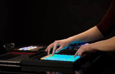 Dj hand remixing music on midi controller
