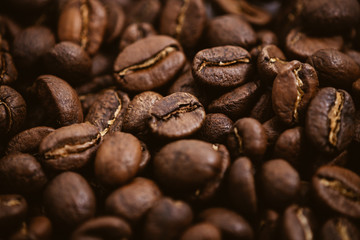 Coffee beans roasted on a wooden table with much of beans with a great aroma