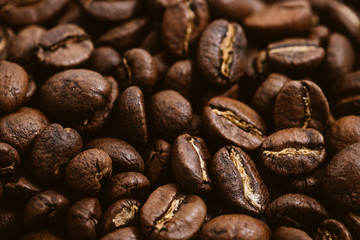 Coffee beans roasted on a wooden table with much of beans with a great aroma