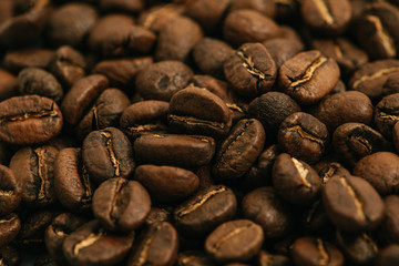 Coffee beans roasted on a wooden table with much of beans with a great aroma