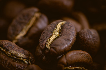 Coffee beans roasted on a wooden table with much of beans with a great aroma