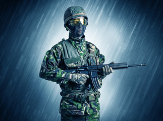 Armed soldier standing in rainy weather
