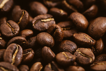 Coffee beans roasted on a wooden table with much of beans with a great aroma