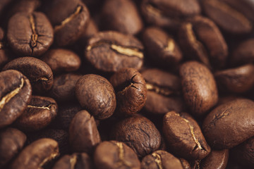 Coffee beans roasted on a wooden table with much of beans with a great aroma