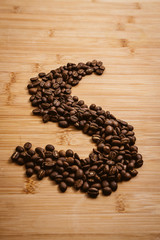 Coffee beans roasted on a wooden table with much of beans with a great aroma