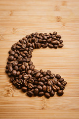 Coffee beans roasted on a wooden table with much of beans with a great aroma