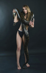 Beautiful girl and giant snake in the studio
