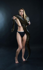 Fototapeta na wymiar Beautiful girl and giant snake in the studio 