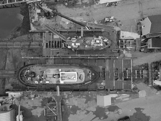Two Tug boats sit in drydock in Rockland Maine as seen from an aerial drone image