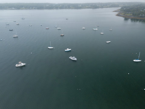 Lobster Fishing boats and other pleasure boats moored in Rockland Harbor inside the Breakwater as viewed from an aerial drone image