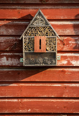 Wooden bug zoo on a shed