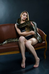 Fototapeta na wymiar sensyal girl and tiger python in the studio 