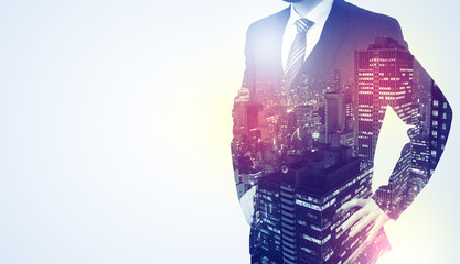  Young businessman standing and thinking with night city background