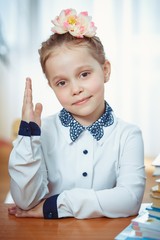 A schoolgirl sits at a desk