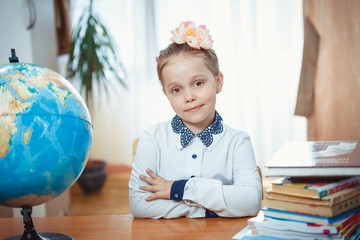 A schoolgirl sits at a desk