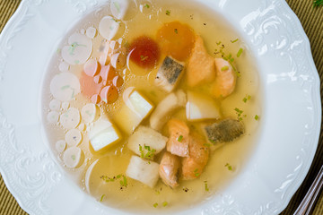Fish soup on white plate