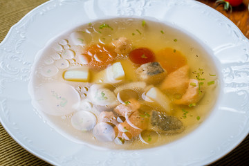 Fish soup on white plate