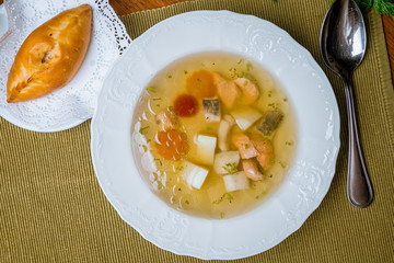 Fish soup on white plate