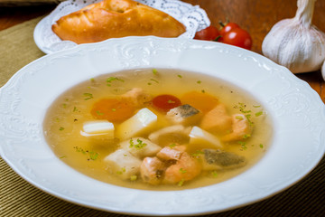 Fish soup on white plate