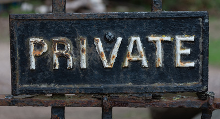 Private sign with rusted white letters