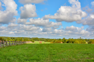 Fototapeta na wymiar Summer cloudy day on a hay meadow.