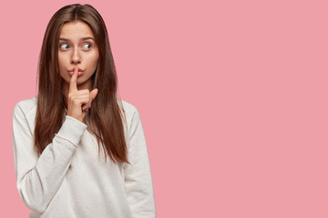 People, body language and secrecy concept. Attractive teenage girl with dark hair, looks...