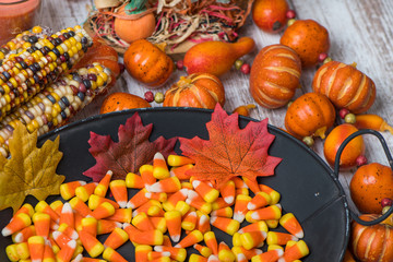 Dish of candy corn with fall decorations