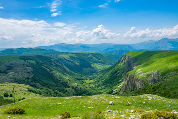 Fototapeta na wymiar Beautiful green meadows stretched among the picturesque mountains.