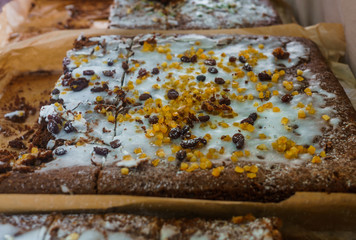 Delicious baked honey homemade cake, filled with glaze and sprinkled with candied fruits and raisins.