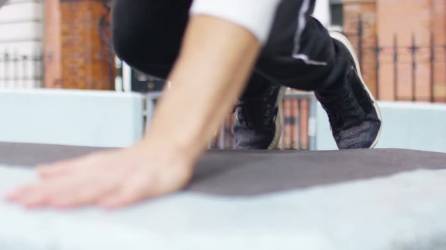 Young parkour male jumping from one wall to another, in slow motion