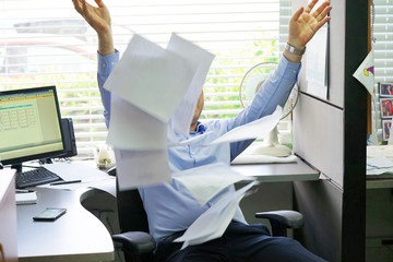 Overworked Angry Businessman Throwing Paper All Over The Office. Stressed businessman throwing...