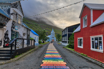 Rainbow pathway in center of town to Seyðisfjarðarkirkja Church - obrazy, fototapety, plakaty