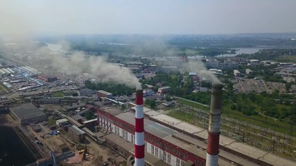 Aerial drone shot of the industrial complex with the city on the background