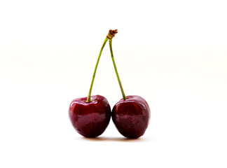 Two shiny sweet cherries isolated on white background. Bright summer berries close-up. Natural vitamin. The concept of organic food and healthy lifestyle.