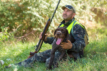 Hunter with a German trotter and spaniel, hunting a pheasant with dogs	