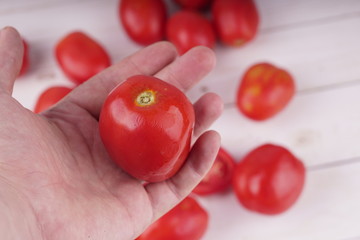 Fresh red tomatoes on wooden background. Qualitative background from tomatoes.