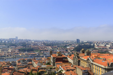 Obraz premium Scenic view of Porto, Portugal from the tower Clérigos Church. River Douro. Orange roofs of the houses.