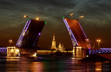 Fototapeta na wymiar Raised Palace bridge over river Neva. Raising of bridges in Saint-Petersburg, Russia. Summer white night.