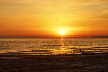 Beautiful sunset over the sea. The sun sets on the water.