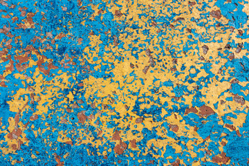 background. original cracked plaster painted in blue and yellow colors