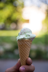 Pistachio gelato in a waffle cone