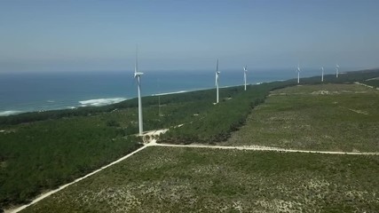 Beautiful aerial drone shot of windmills on the field