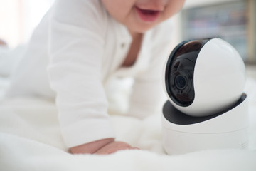 Baby monitor camera with blurred baby background for text space. concept of baby safty