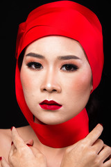 Asian tanned skin woman with strong color red lips