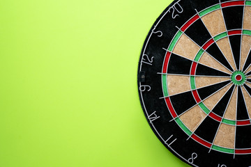 Target dart board on the green background, center point, head to target marketing and business success concept