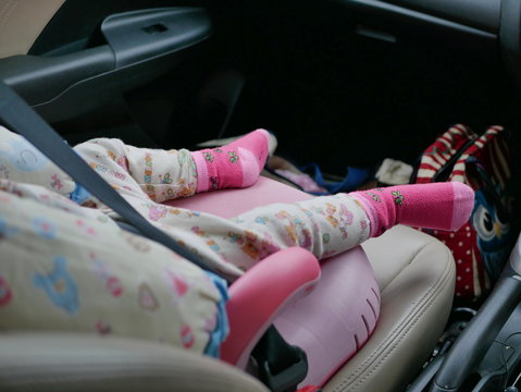 Sleeping Little Asian Baby's Feet In A Driving Car Without A Proper Baby Carseat