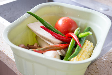 Clean vegetables and other ingredients are placed in the basket